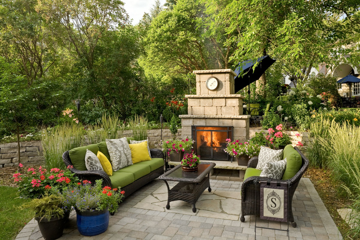 Gather around the outdoor fireplace in this beautiful patio design by Villa Landscapes. 