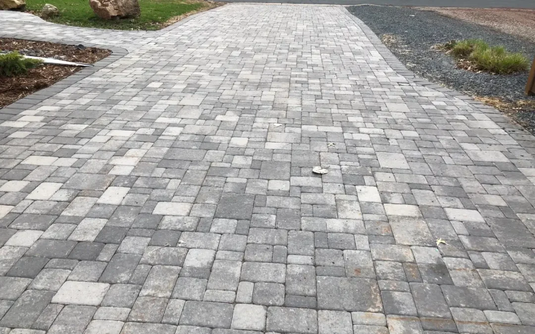 What is the Correct Base Preparation Process for a Paver Driveway Installation to Withstand Heavy Vehicle Traffic?