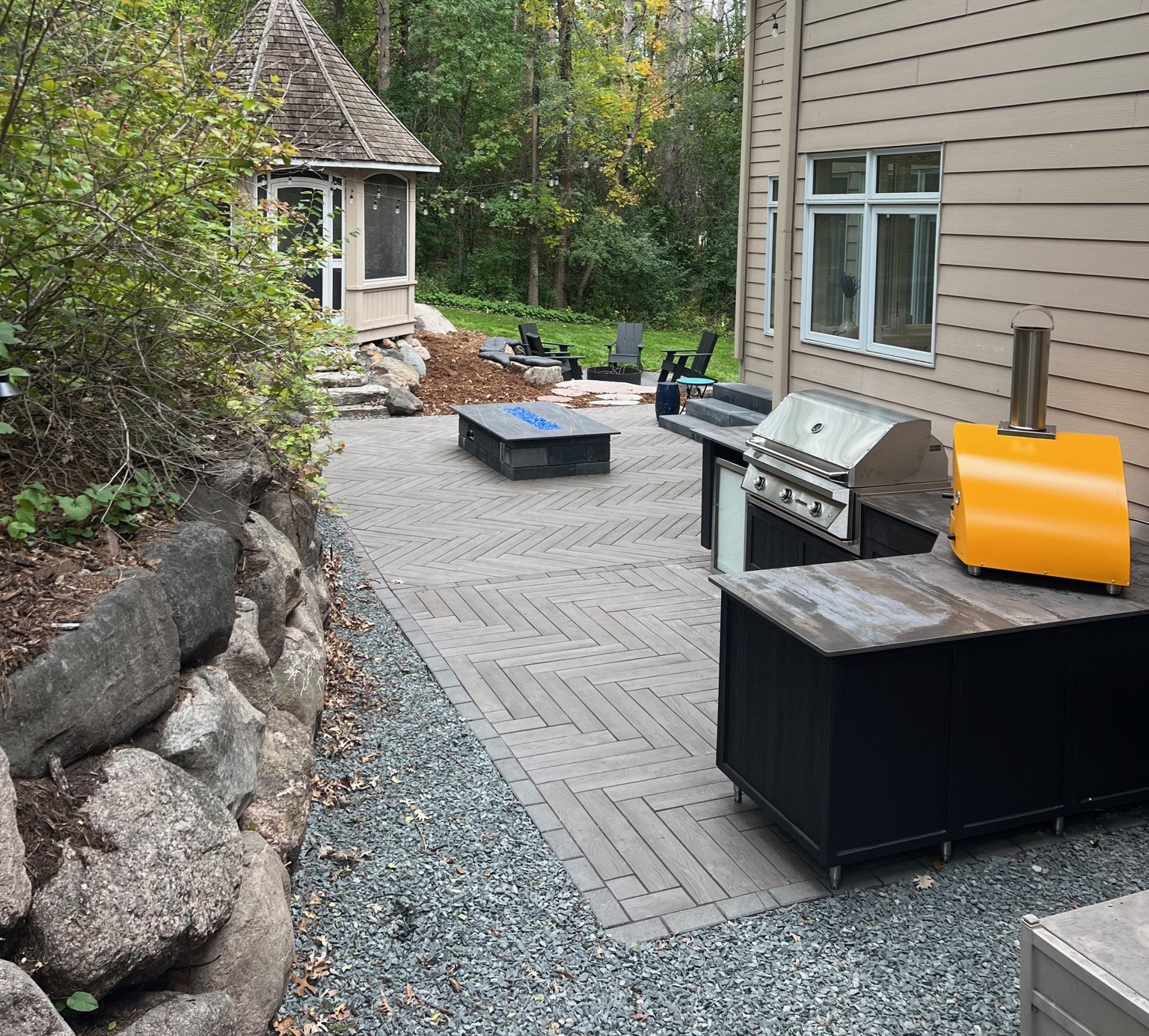 Black outdoor kitchen and pizza oven with grill in Edina mn